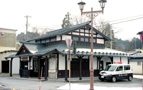 Free A traditional Japanese police station in Senboku City, featuring a snowy landscape and a patrol car. Stock Photo