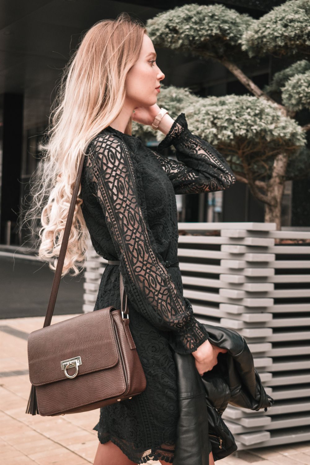 Woman in leather jacket with lace midi dress