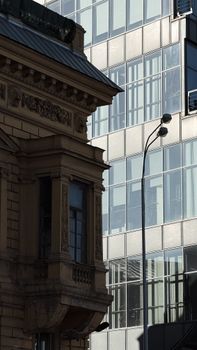 Intersection of traditional and modern architecture showcasing intricate designs and sleek glass lines.
