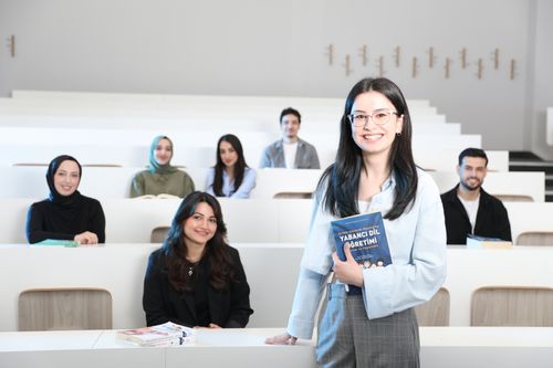Free Group of diverse university students in a bright lecture hall, studying language education. Stock Photo