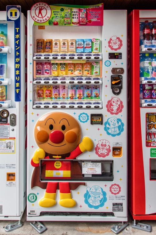 Free Vibrant vending machine featuring Anpanman in Kurashiki, Japan. Perfect for collectors. Stock Photo