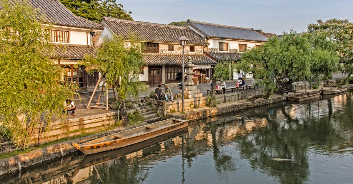 Experience the tranquil beauty of Kurashiki's historic canal surrounded by traditional architecture and lush greenery.