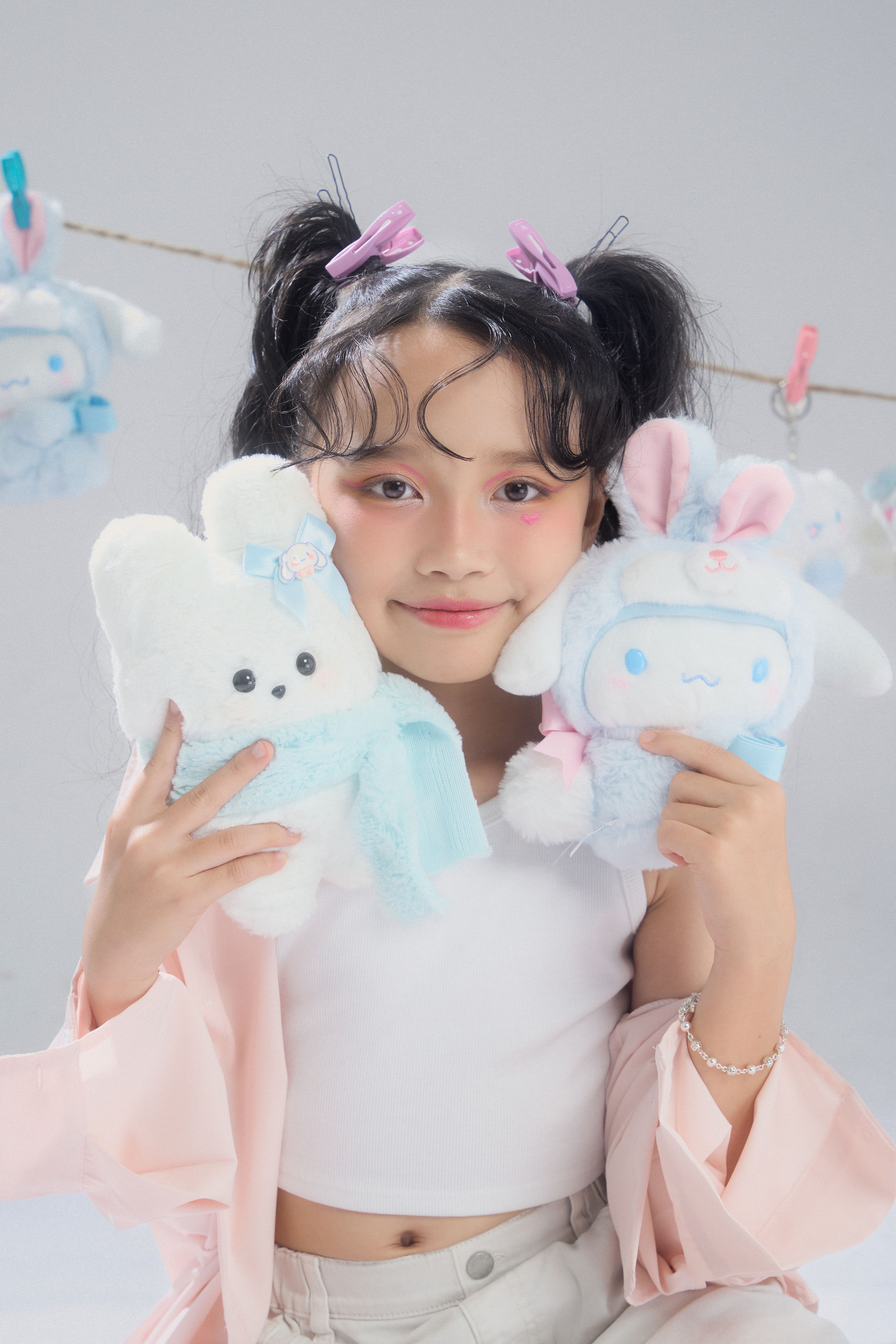 A cute girl posing with plush toys, embracing fashion with a youthful vibe.
