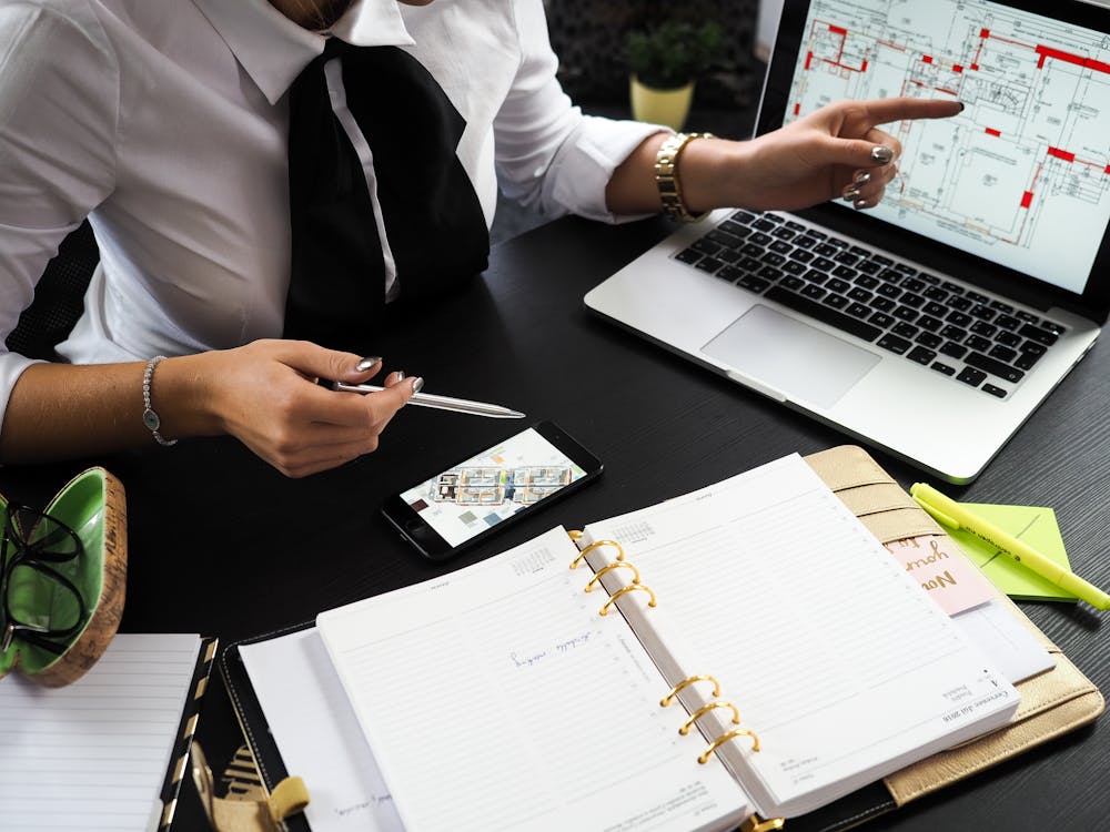 Free Person Pointing on the Screen of a Laptop Stock Photo