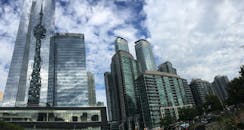 Low Angle View of Skyscrapers Against Cloudy Sky