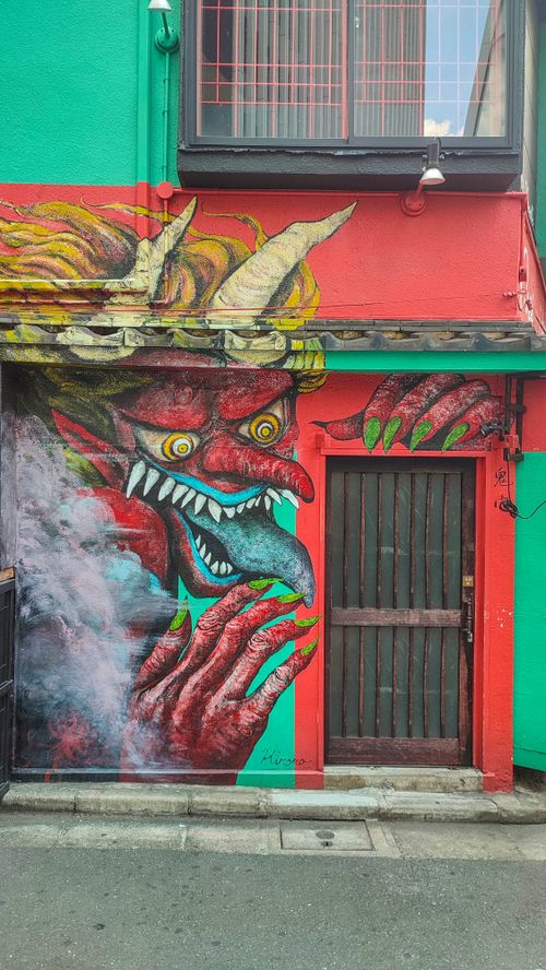Free Colorful demon mural on a building wall in a Tokyo street, showcasing vibrant urban art. Stock Photo