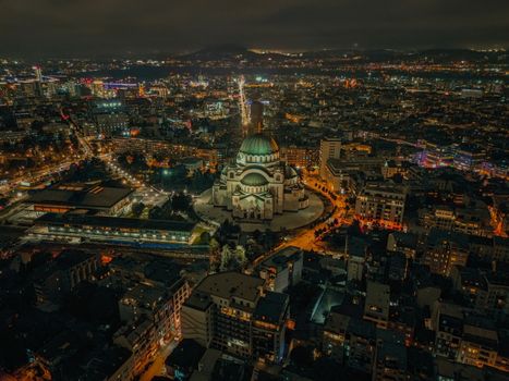 A stunning aerial night view of Saint Sava Cathedral in Belgrade, showcasing its magnificent architecture.