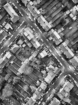 Black and white aerial photo showcasing a suburban neighborhood with intersecting streets and houses.