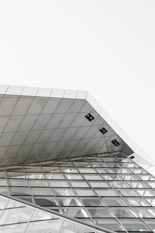 Free Low Angle Shot Of A Modern Glass Building In Black And White Stock Photo