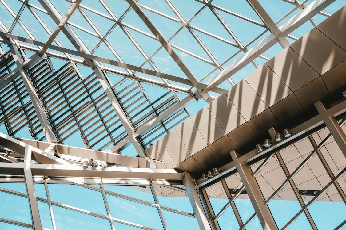 Low Angle Shot From inside Of A Modern Building Made Of Steel And Glass Panels