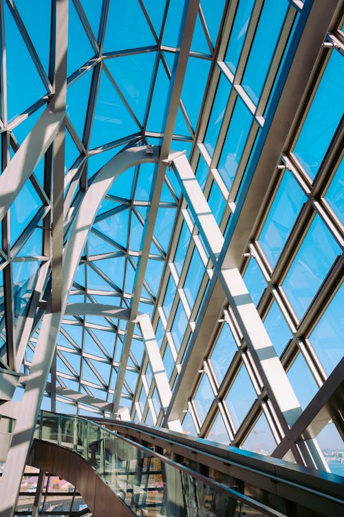 Low Angle Photo of Ceiling and Glass Wall