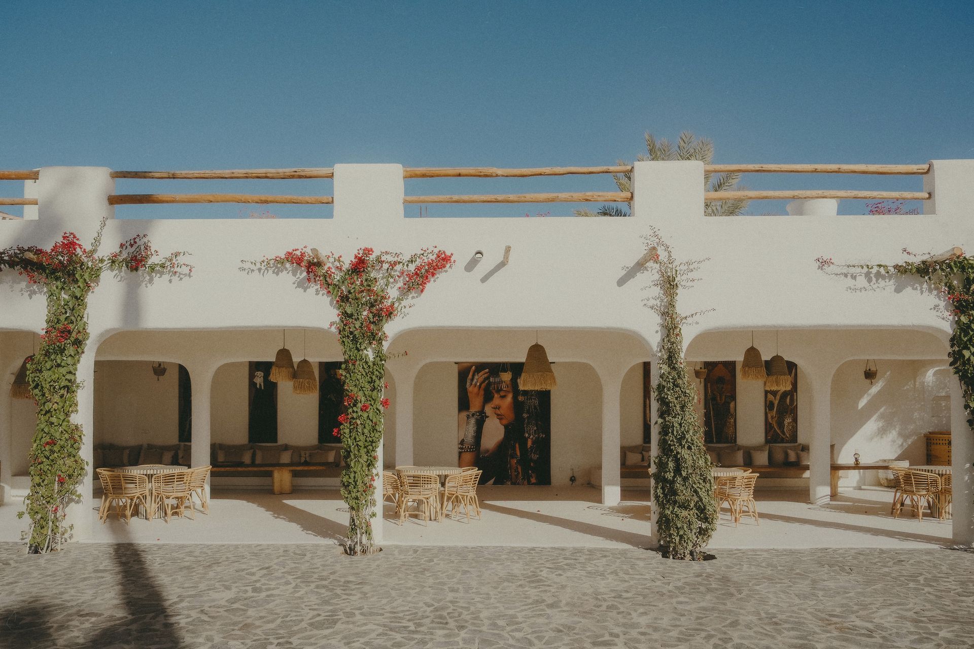 Elegant Moroccan courtyard in Marrakesh featuring traditional architecture and vibrant greenery.