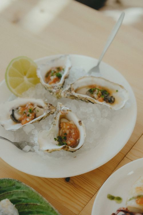 Free Plate of fresh oysters served on ice with lime, offering a taste of Marrakesh. Stock Photo