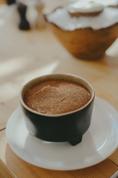 Free Warm and aromatic Moroccan spiced tea served in a traditional ceramic cup on a sunny table. Stock Photo
