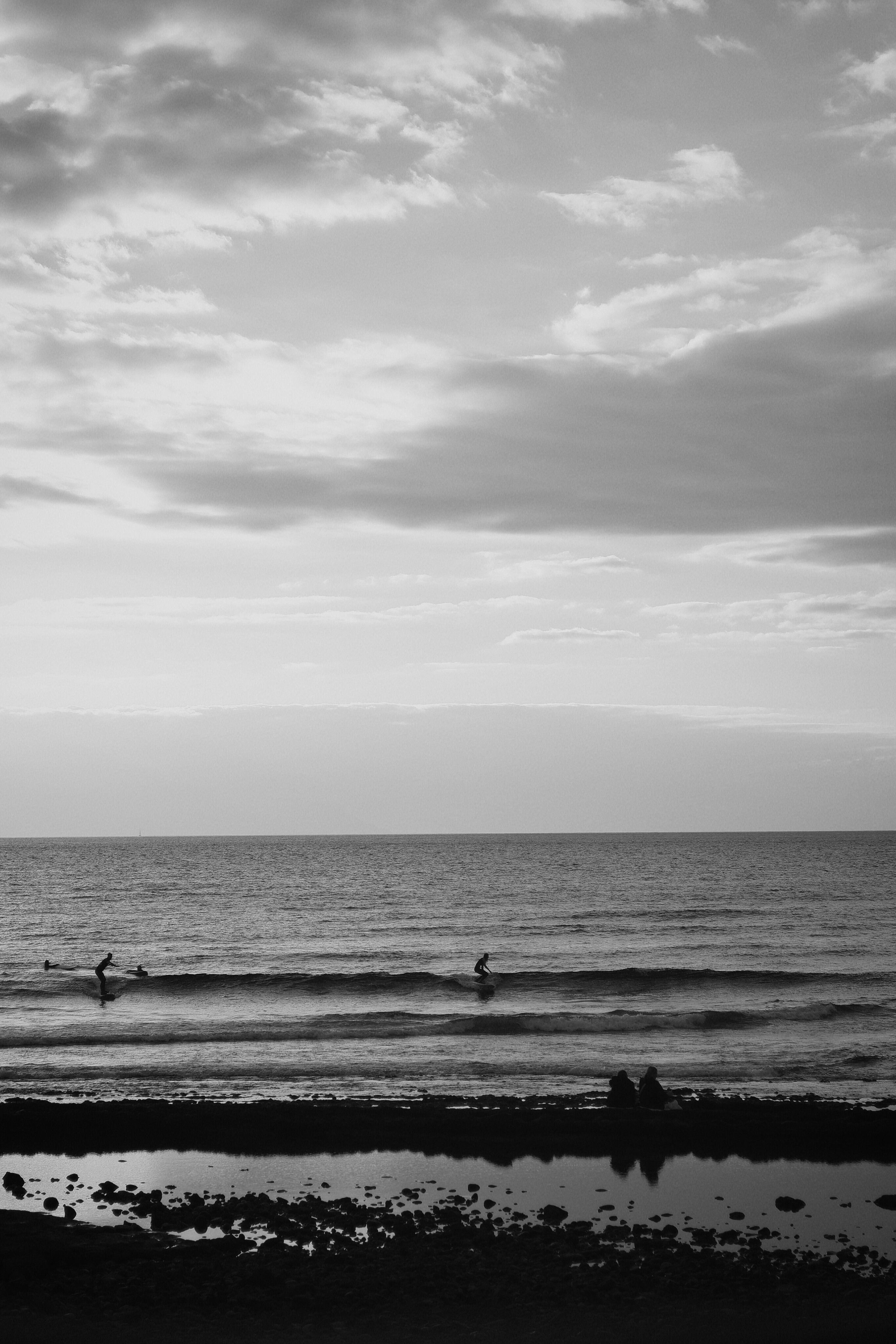 Black and White Beach Sunset with Surfers · Free Stock Photo
