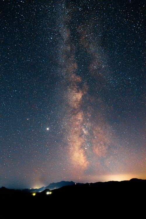 Free Stunning view of the Milky Way galaxy glowing over a serene mountain landscape at night. Stock Photo