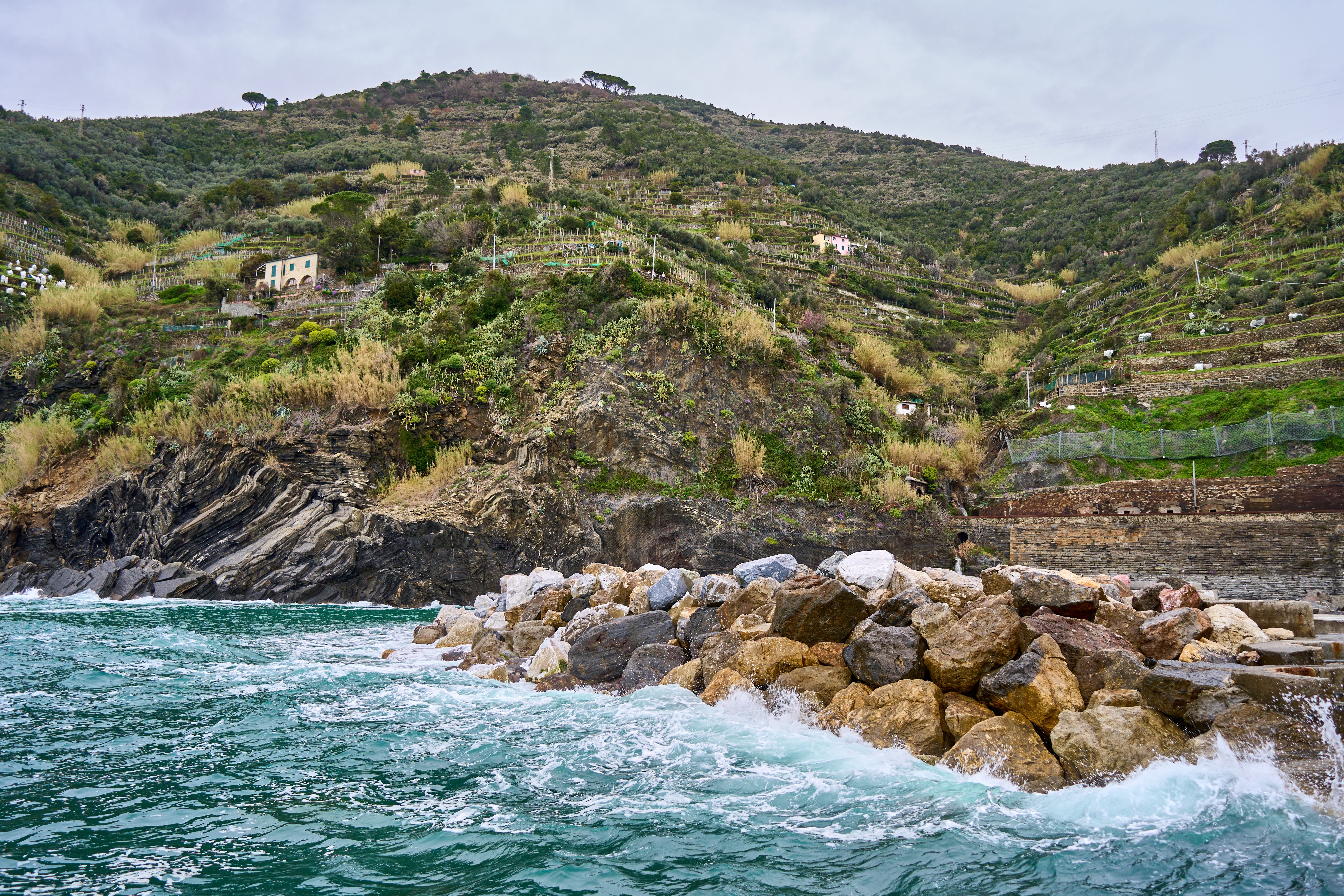 Scenic view of a rocky coastline and terraced vineyards in Italy during daytime