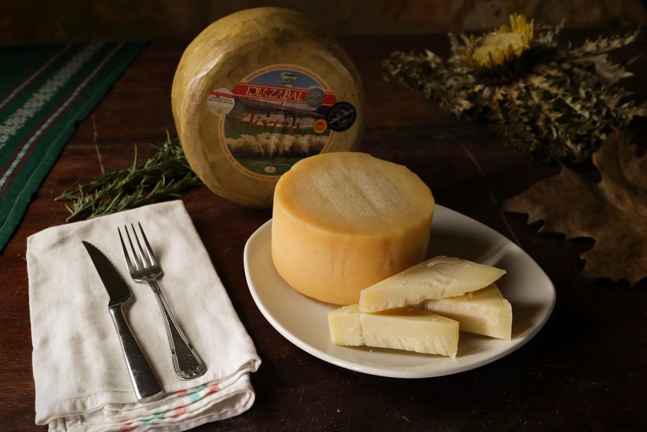Queso fresco español sobre tabla de madera en una quesería tradicional