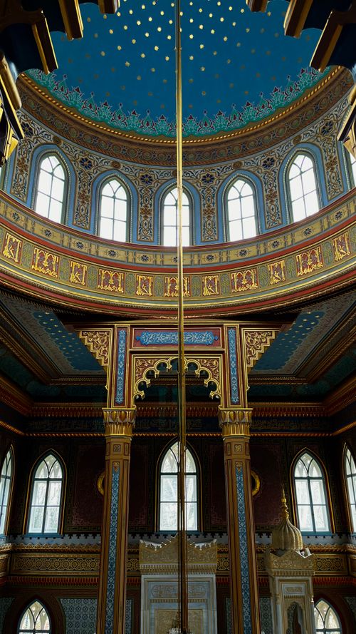 Free Elegant architectural details of an ornate dome interior with colorful patterns and arches. Stock Photo