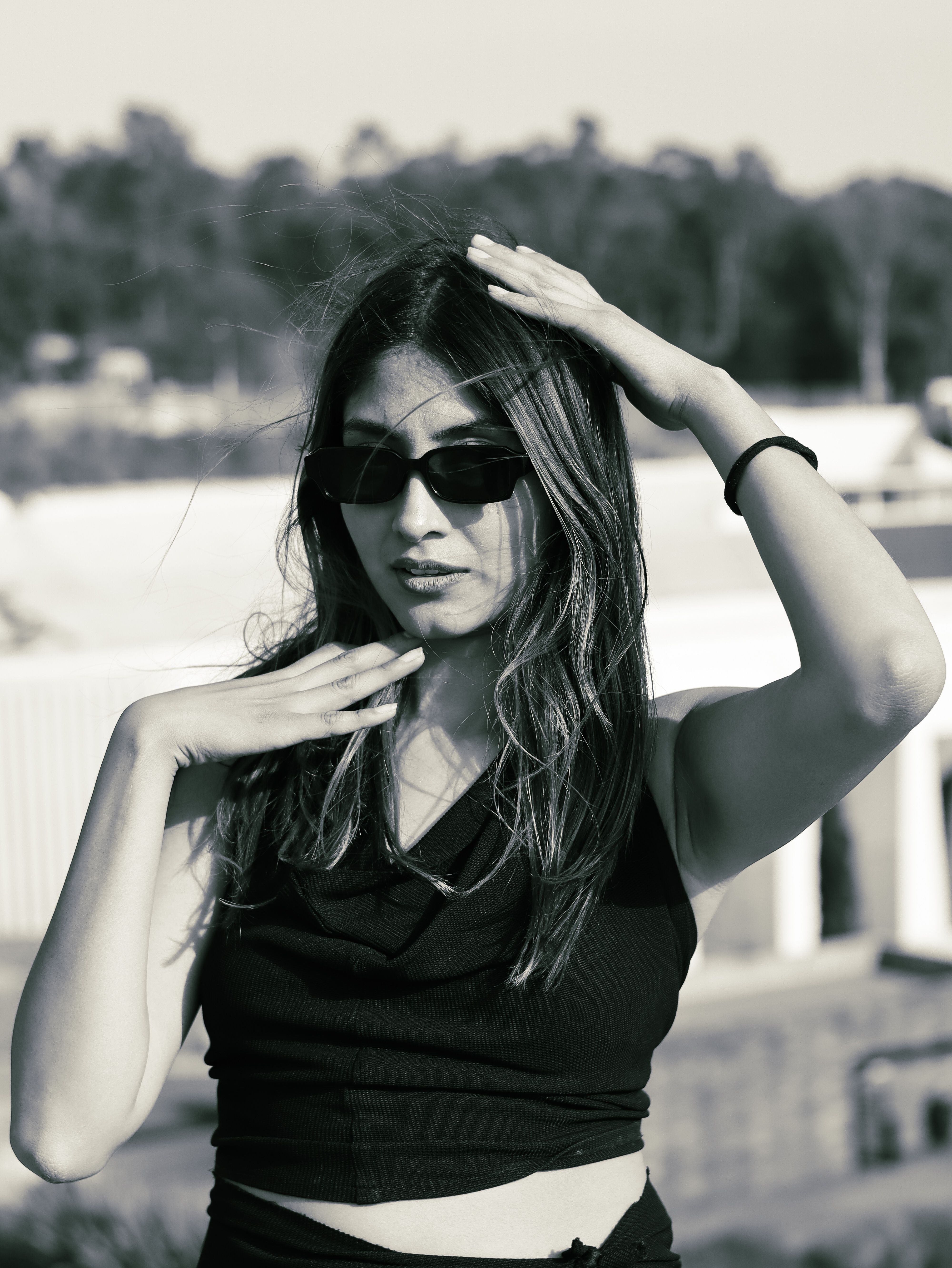 Stylish Woman Posing Outdoors in Sunglasses · Free Stock Photo