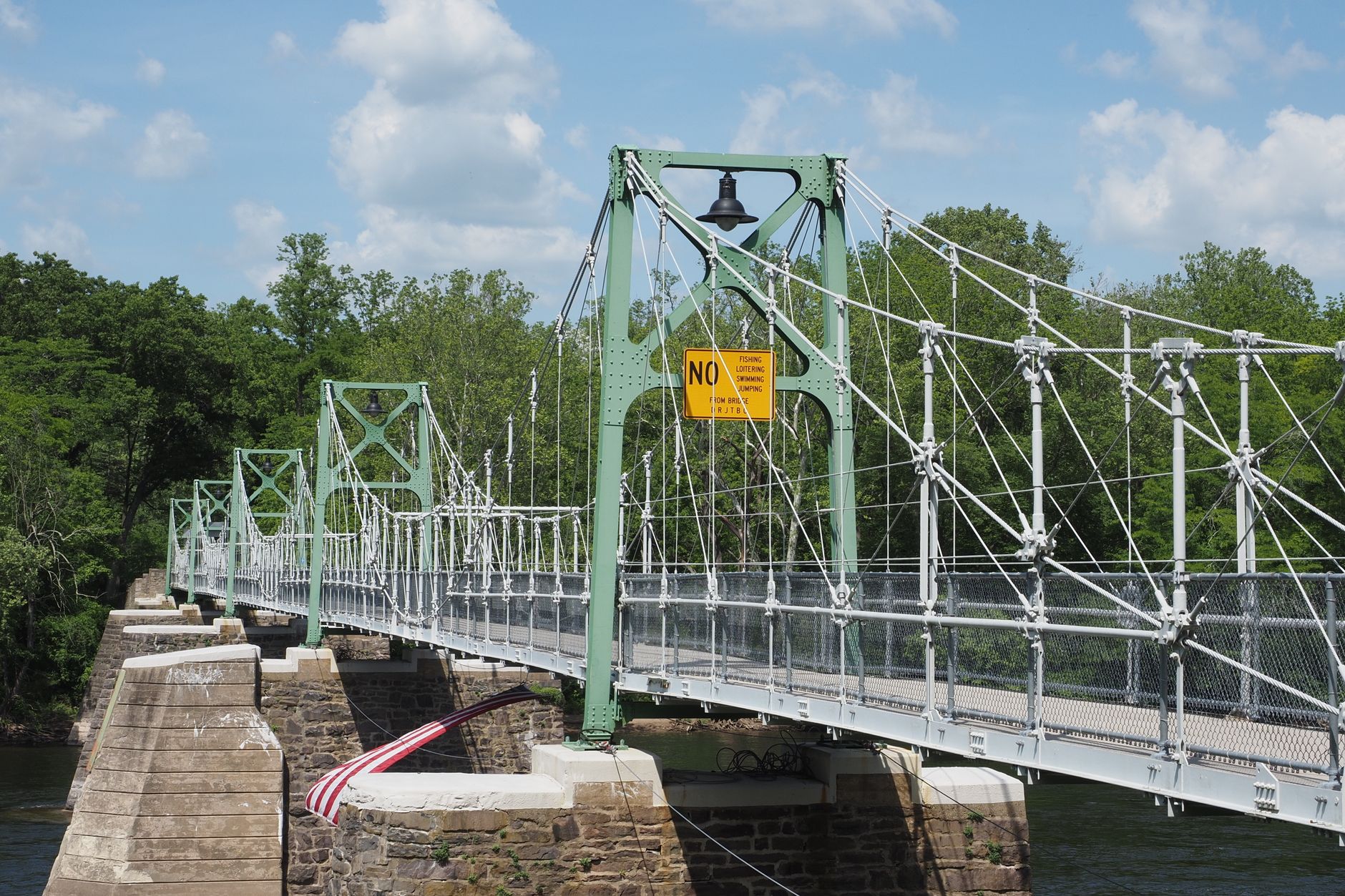 A scenic view of the Upper Black Eddy suspension bridge over the Delaware River.