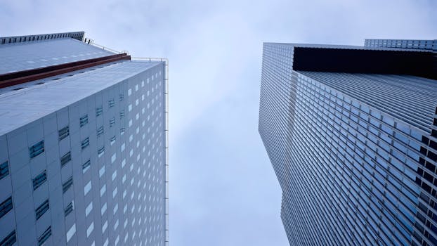 Low angle view of modern skyscrapers in Rotterdam, showcasing architectural elegance and urban style.