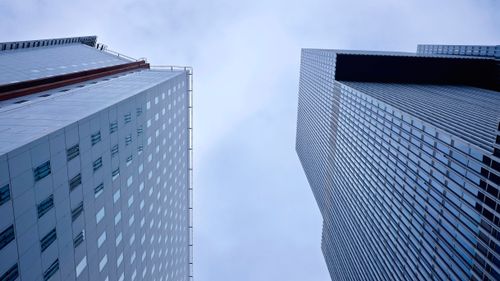 Free Low angle view of modern skyscrapers in Rotterdam, showcasing architectural elegance and urban style. Stock Photo