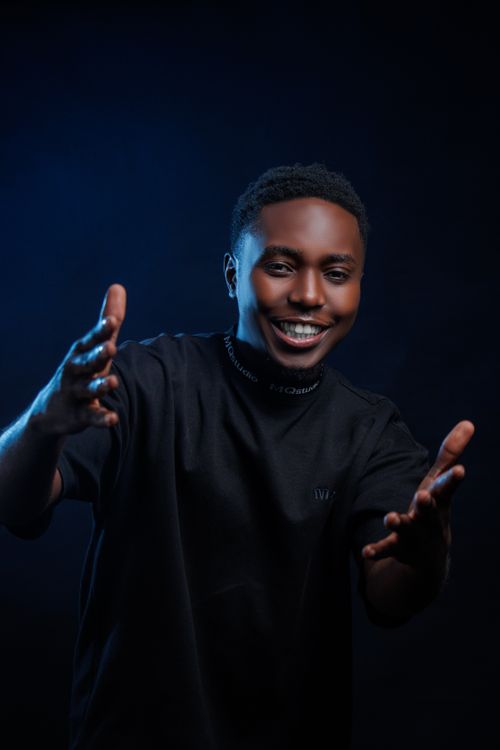 Dynamic Portrait of Smiling Young Man in Black · Free Stock Photo