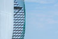 Curved Metal Staircase Against Blue Sky