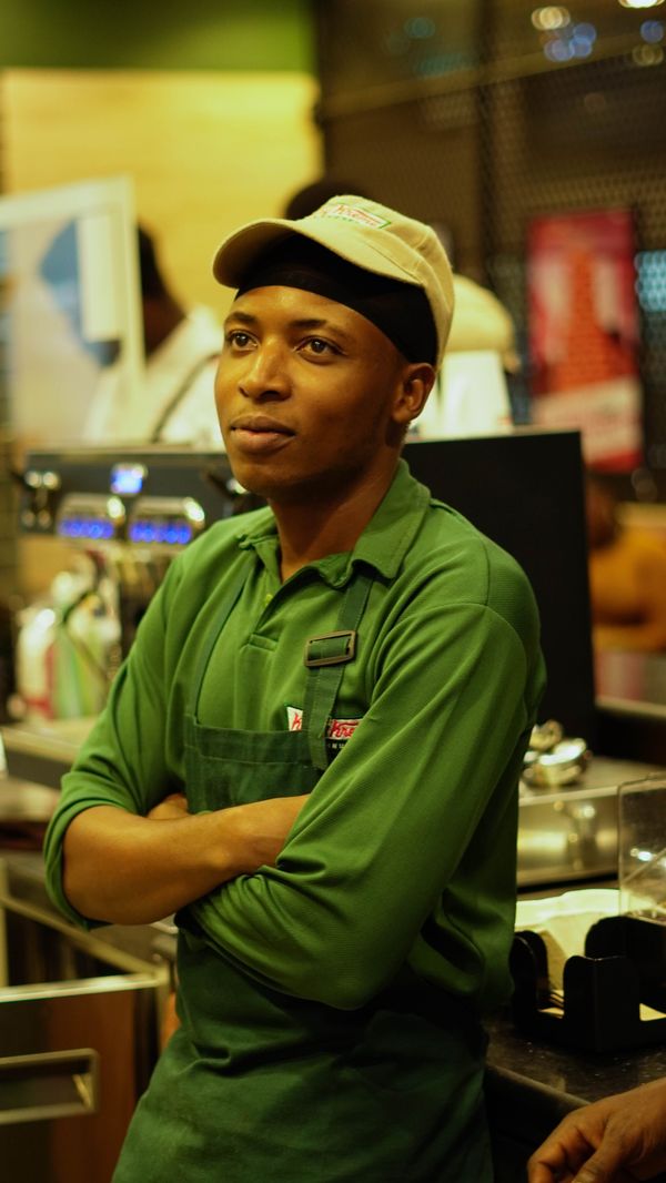 Barista in green apron at coffee shop