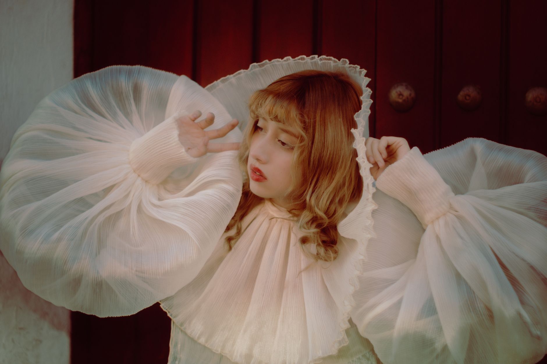 Artistic portrait highlighting a woman in a billowy, theatrical costume with a vintage flair.