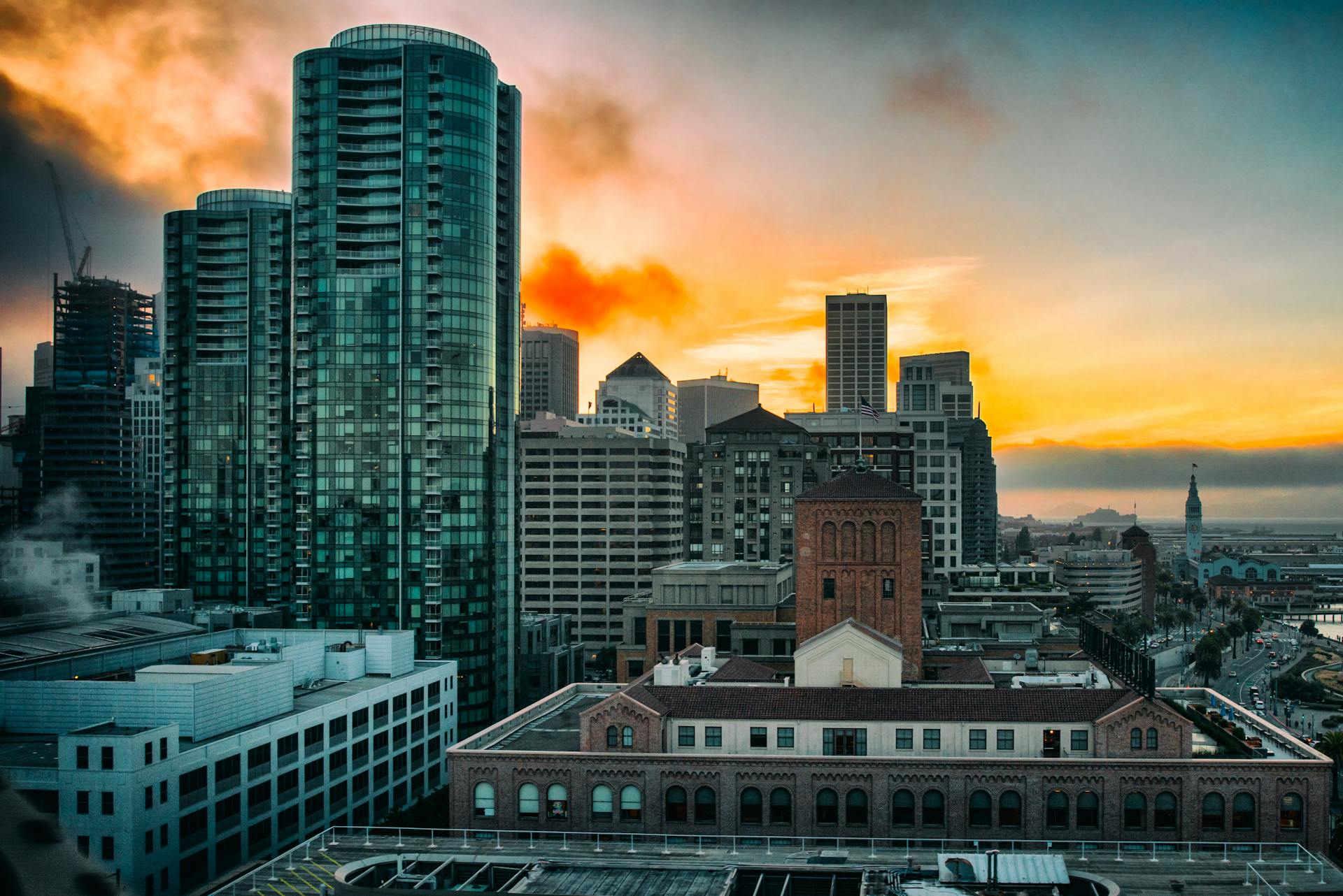 A vibrant sunset over the San Francisco skyline featuring modern skyscrapers and urban landscape.