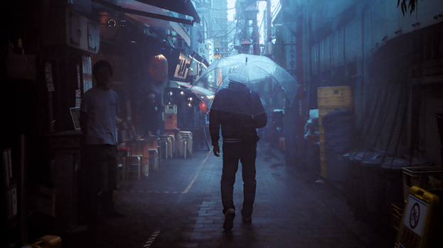 A solitary figure with an umbrella walks through a rainy alley in Shinjuku, Tokyo, illuminated by captivating neon lights.