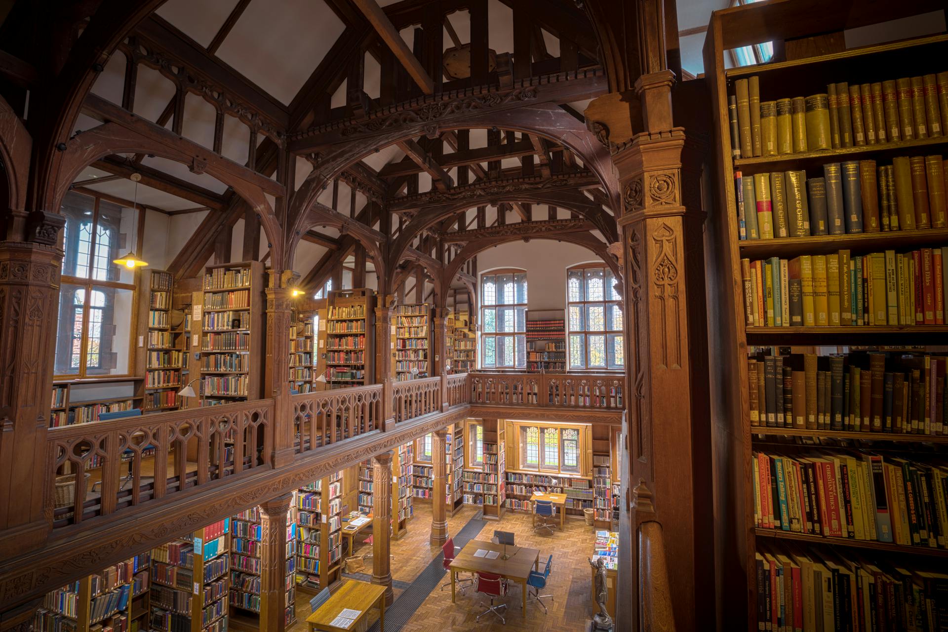 Elegant interior of a historic library in Hawarden, showcasing wooden architecture and bookshelves.