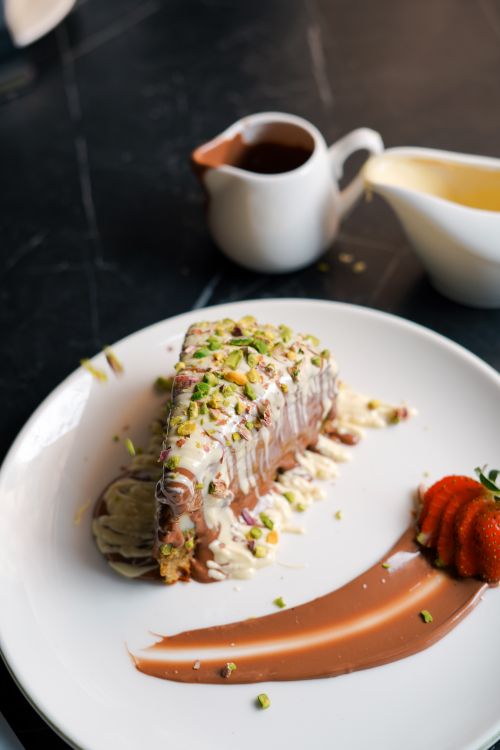 Free Indulge in this gourmet chocolate cake topped with pistachios and fresh strawberries, perfect for dessert lovers. Stock Photo
