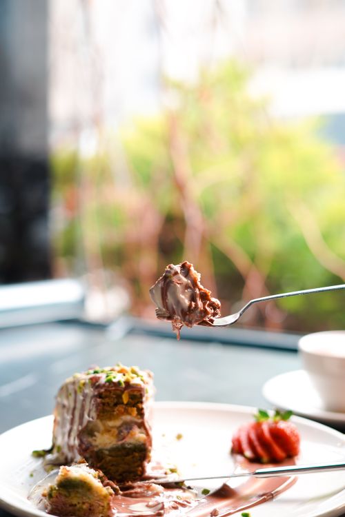 Free Indulge in a rich chocolate dessert served inside a cozy café, perfect for sweet tooths. Stock Photo