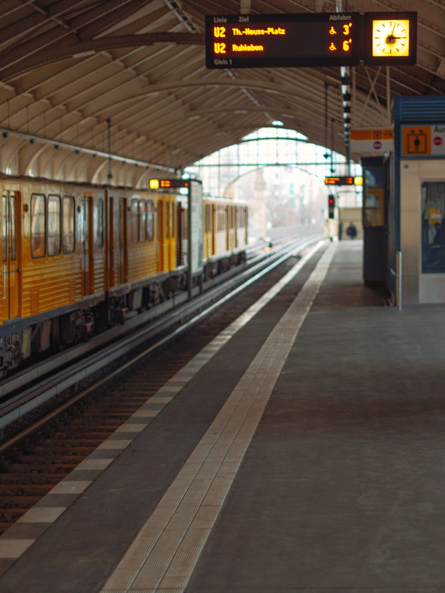 A yellow U-Bahn train in a Berlin underground station