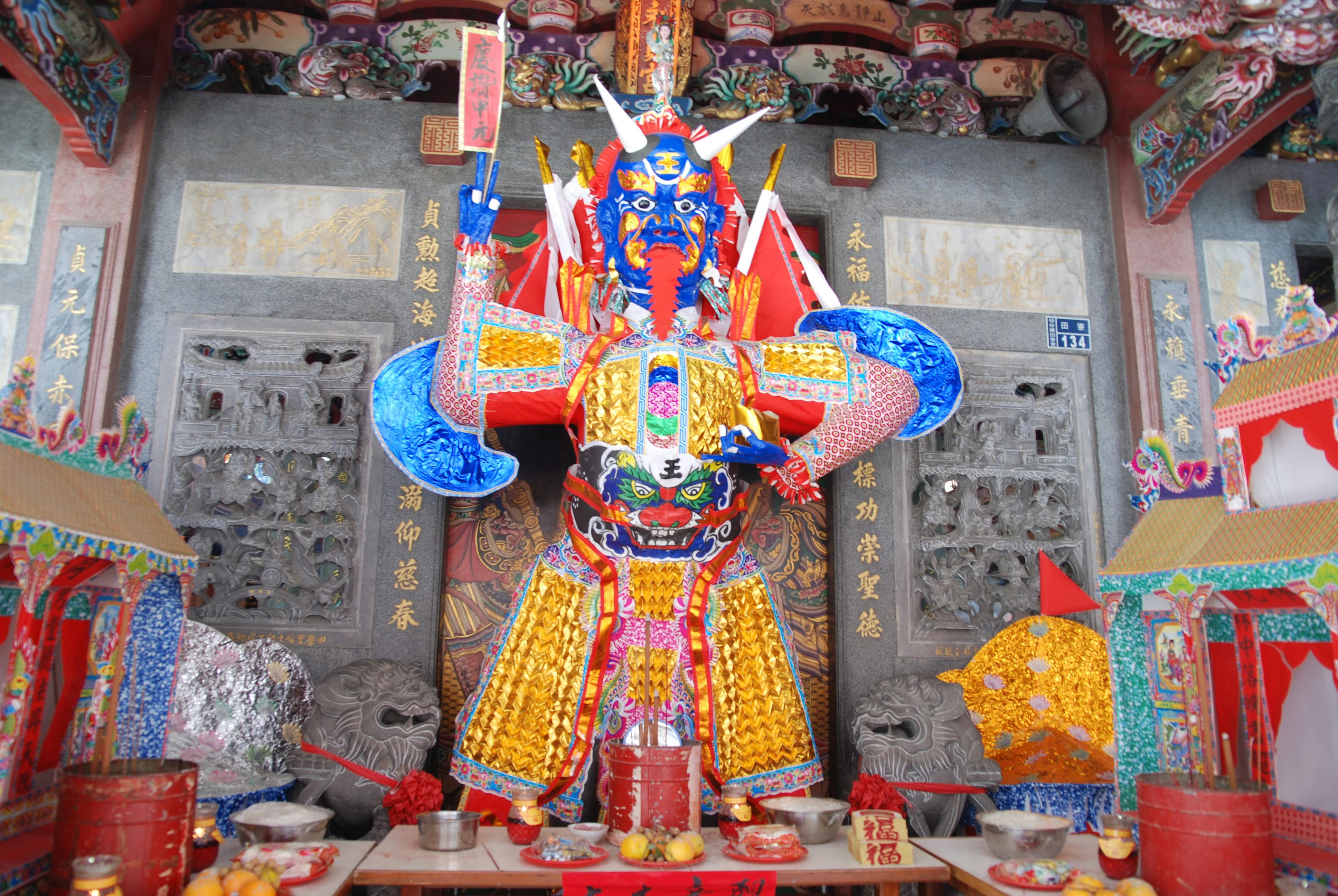 Colorful warrior sculpture in a Chinese temple, rich in cultural symbolism and detailed artistry.