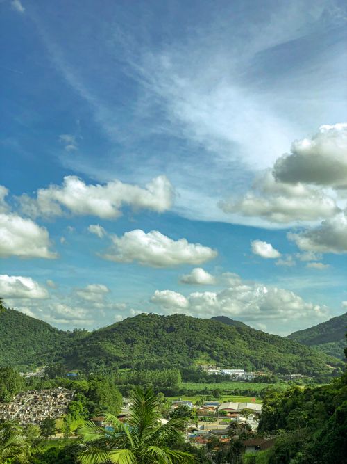 Free Breathtaking view of Serra do Mar mountains under a clear blue sky with fluffy clouds. Stock Photo