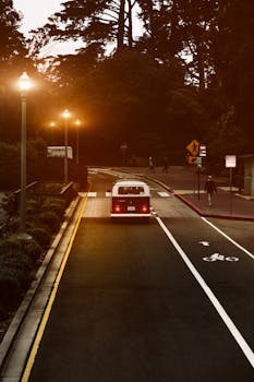 黄昏时分，一辆老式货车驶过旧金山，在温暖的路灯下