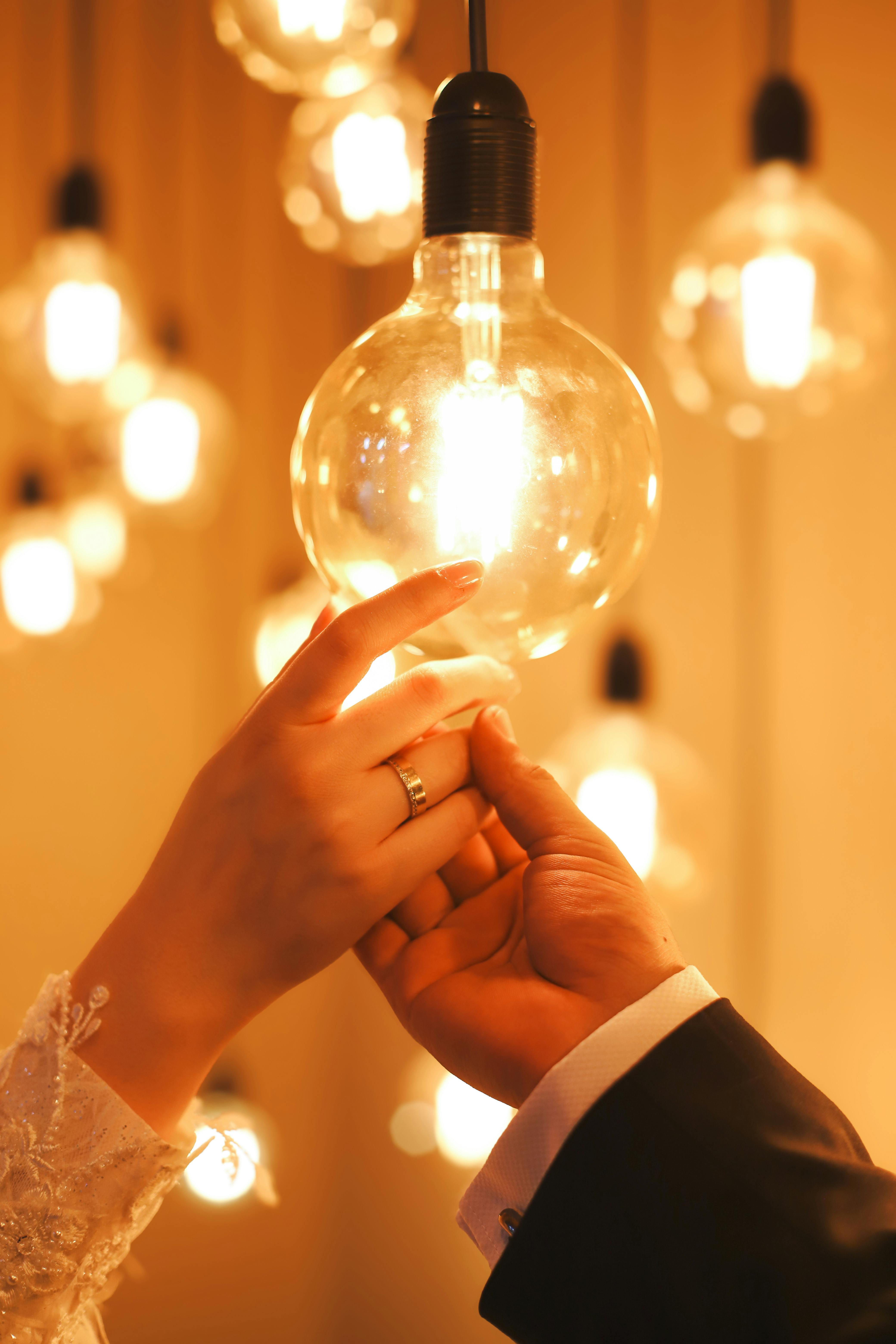 Romantic Hands Touching Light Bulb · Free Stock Photo, image size:4160x6240