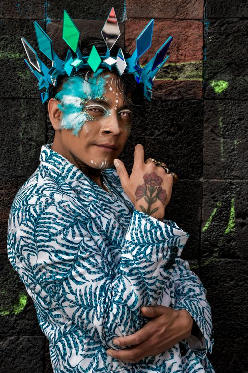Free A vibrant artistic portrait showing a person with blue geometric crown and expressive face paint, embodying creativity. Stock Photo