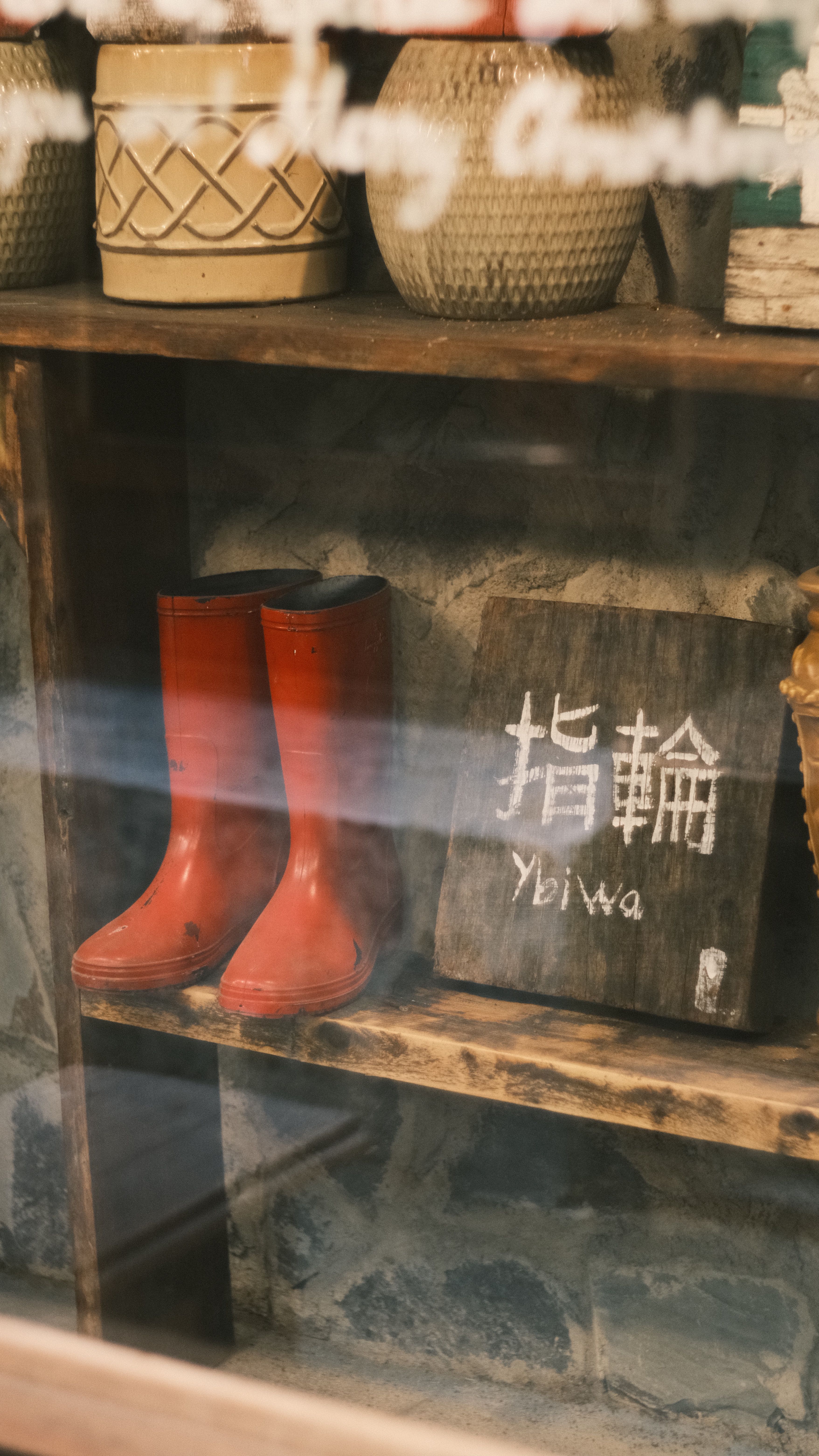 Rustic Display Featuring Red Boots and Sign · Free Stock Photo
