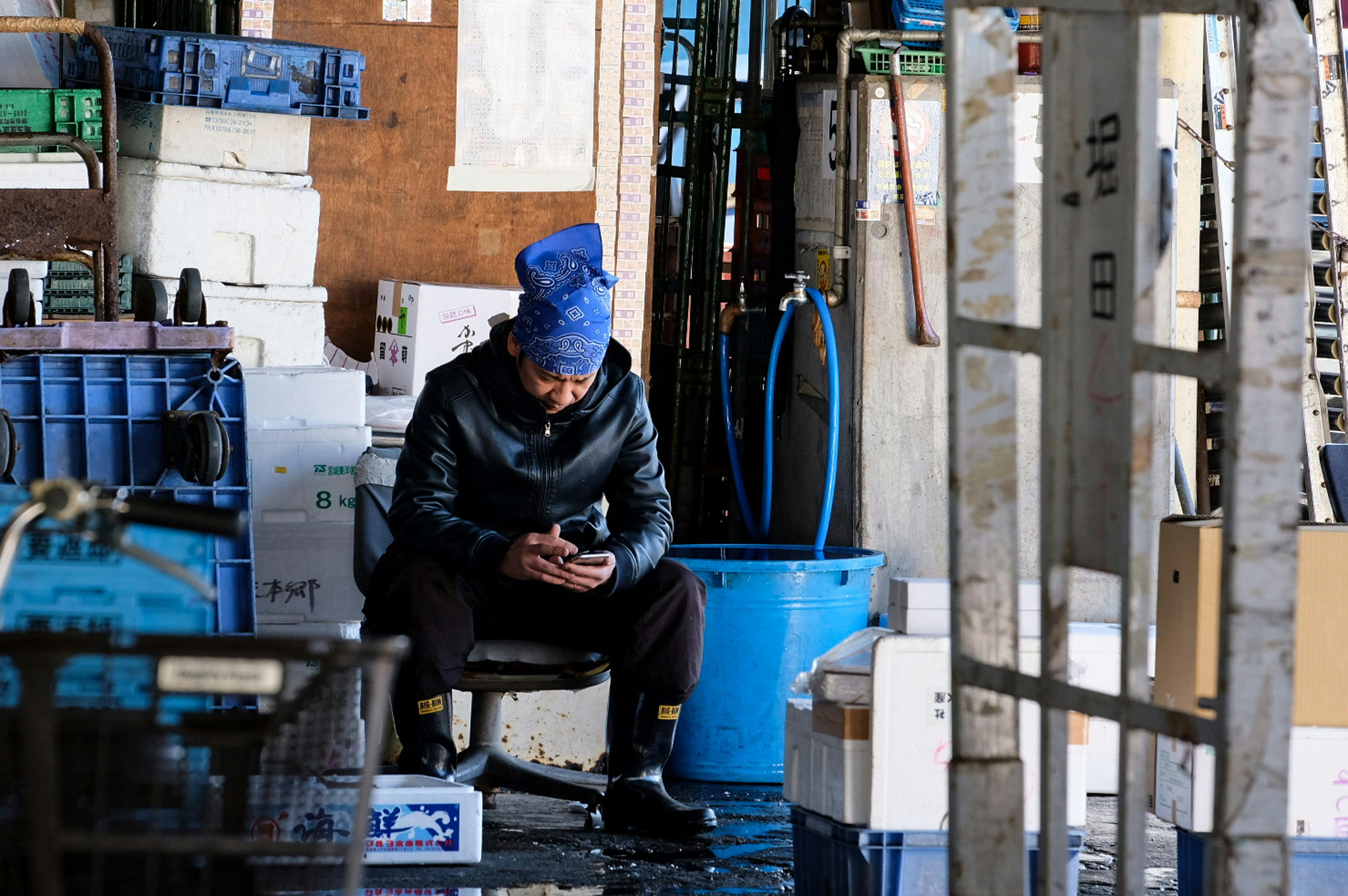 Warehouse worker with a rugged phone on the floor