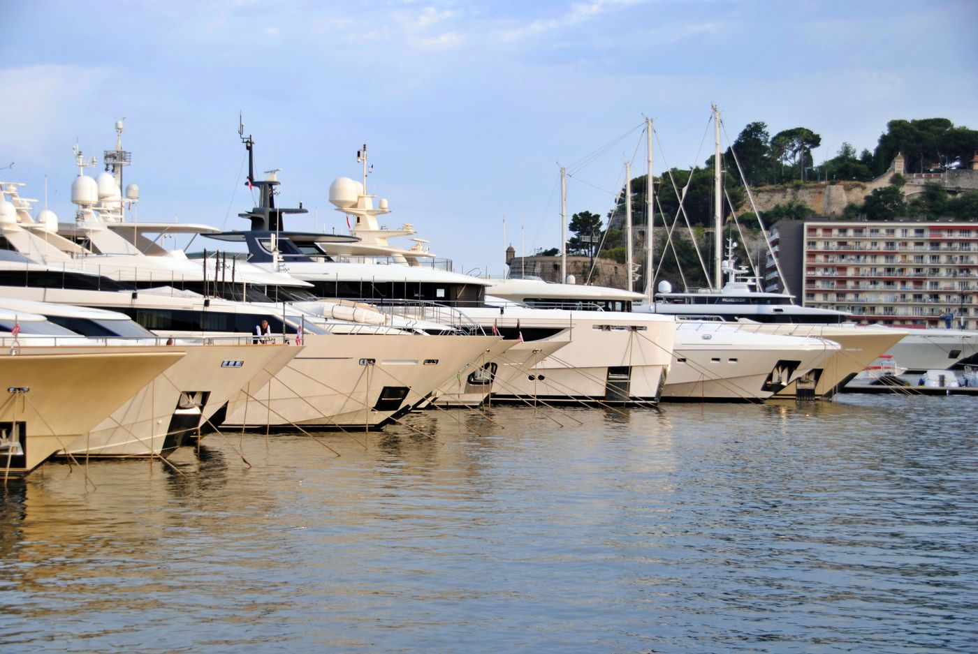 Row of superyacht bows moored stern-to in a marina