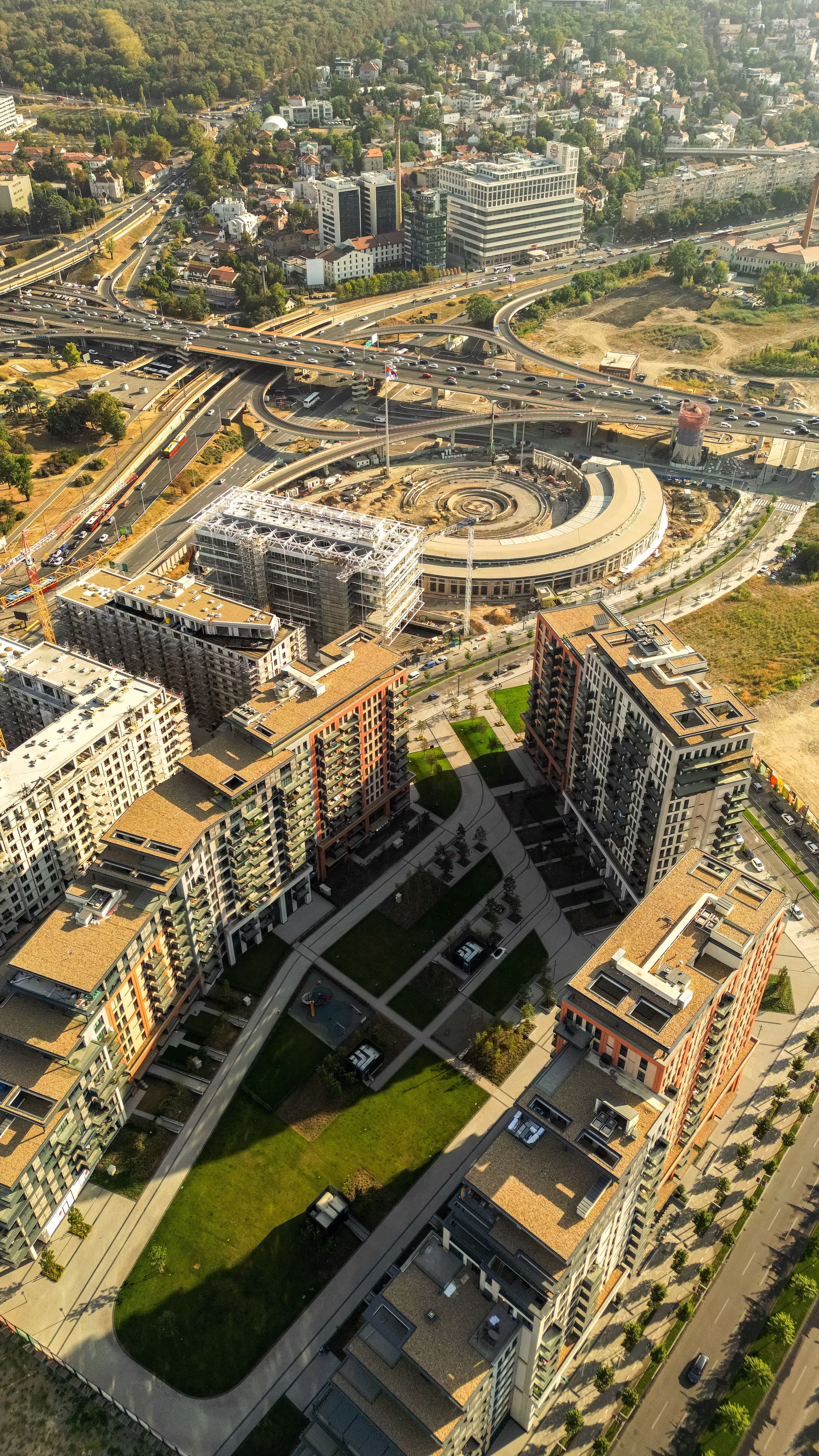 Aerial shot of modern buildings and highway in Belgrade, Serbia showcasing urban development.