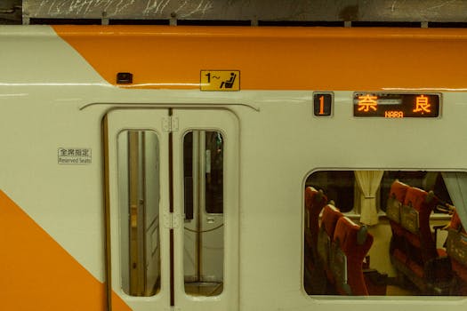 Close-up of a modern train bound for Nara in Japan, showcasing seating arrangements.