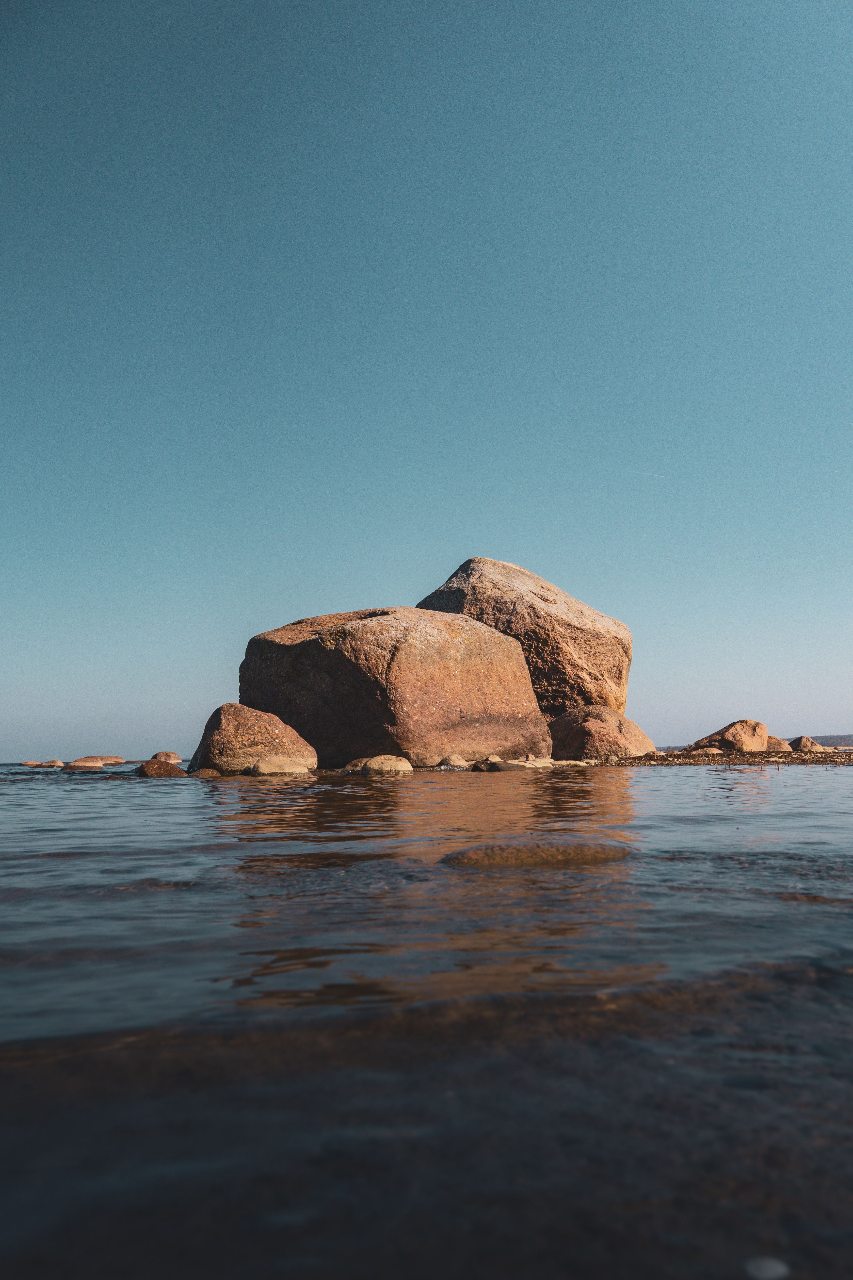 Serene Coastal Rocks against Clear Sky · Free Stock Photo