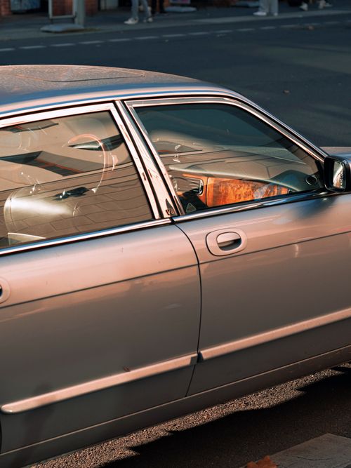 Free Close-up of a classic car door in Berlin with reflection, capturing city ambiance. Stock Photo