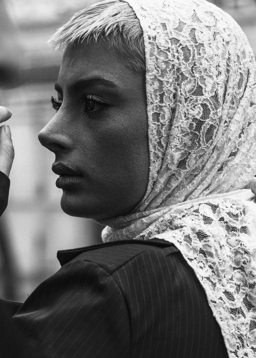 Free Striking black and white portrait of a woman wearing a lace scarf, exuding elegance and style. Stock Photo